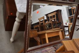 A reproduction mahogany effect gilt mirror, approx. 86 x 59cm