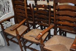A set of eight (six plus two) traditional oak ladder back chairs having rush seats