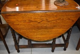 An early to mid 20th Century oak oval top gateleg dining table, approx width 90cm, open length