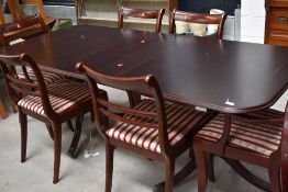 A reproduction Regency style mahogany extending dining table and set of six (four plus two)