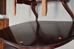 A Reproduction Regency style dining table , mahogany effect with gadrooned border, approx. length
