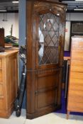 A mid to late 20th century corner display cabinet with lower cupboard section, in the Priory