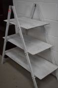 A folding painted shelf unit, very portable, ideal for the fairs or a stall