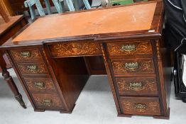 A late Victorian flame mahogany kneehole desk, having satinwood banding and inlay decoration in