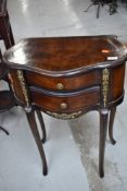 A good quality reproduction mahogany and walnut side table having two frieze drawers, French