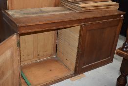 An early 20th Century golden oak bookcase, having double cupboard under, with interesting additional