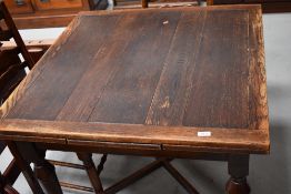 An early 20th Century oak drawer leaf table, square closed form on X frame, approx. width 91cm