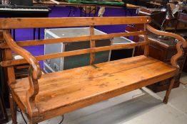A large hardwood bench with brass and iron fixings , of Indian origin, quite possibly from railways,