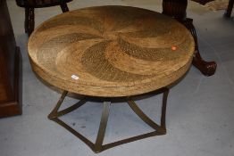 A modern exotic wood coffee table having swirl mosaic pattern top on metal base approx. diameter