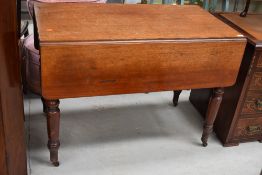 A Victorian mahogany drop leaf dining table, on turned legs and brass casters, width approx 107cm