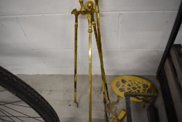 A selection of polished brass fire tools, including footman