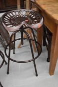 A cast adjustable stool, modelled as vintage tractor or implement seat, with bronze effect finish