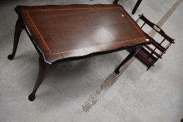 A reproduction Regency style mahogany coffee table and a rosewood effect magazine rack