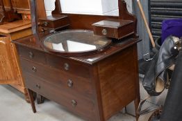 An early 20th Century mahogany dressing table, width approx. 107cm with oval mirror