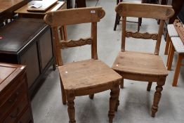 A pair of 19th Century stripped rail back dining chairs having solid seats