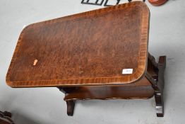 A reproduction inlaid coffee table with book trough under, width approx. 68cm