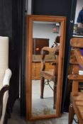 A modern pine wall mirror, approx. 129 x 44cm