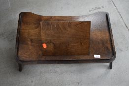 An early 20th Century oak ply bed table/desk