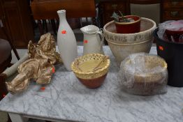 A selection of planters, ornamental cherub etc