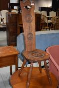 A traditional oak spinning chair having rosette decoration
