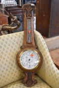 A late 19th/early 20th Century oak cased aneroid barometer of banjo form, dial marked Admiral