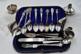 A cased part set of silver child's cutlery, similar spoon and fork, a selection of white metal