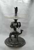 A silver plated table centre modelled as a desert scene with camel and palm tree with etched glass
