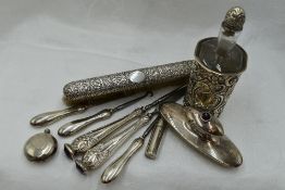 A Victorian glass bottle having silver embossed cover and stopper, Birmingham 1898, Arthur Wilmore