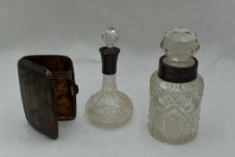 Two cut glass scent bottles with white metal and HM silver collars and glass stoppers and a small