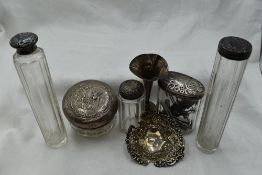 Five assorted glass dressing table pots having HM silver lids, a small HM silver bud vase and HM