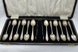 A cased set of twelve silver teaspoons of plain form bearing J monogram to terminals with matching