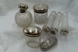 A selection of glass dressing table pots and a spherical cut glass scent bottle, all having HM