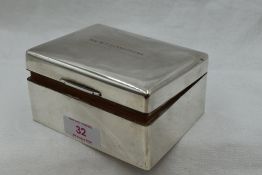A silver cigarette box of plain form bearing presentation inscription to lid, Sheffield 1950, Walker