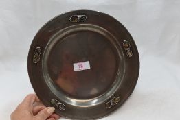 An Edwardian Tudric pewter plate no:0108 of plain Arts & Crafts form designed by Archibald Knox