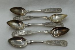 Five 19th Century Russian silver spoons of fiddle back form bearing ornately decorated terminals,