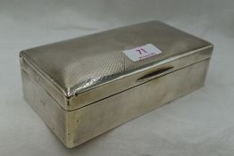 A silver cigarette box of rectangular form having sun burst decoration to lid and monogrammed