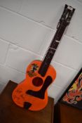 A vintage plastic toy guitar, 'Beatles Big6', pictorial sticker worn, printed signatures , no box