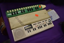 A Casio VL-Tobe, electric melodeon style instrument (VL-1) and a traditional Hohner Melodeon