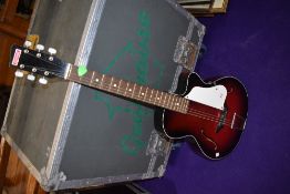 A vintage Egmond acoustic guitar and a BM junior guitar