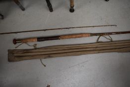 A vintage 12ft cane rod with spare tip in sleeve, unmarked