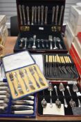 An assortment of canteens of cutlery, including silver plated spoons, fish knifes and forks, cake