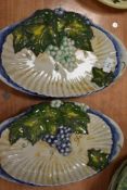 Two dramatic shell shaped dishes with raised grape and vine hand painted designs. bearing the name