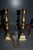 A pair of heavy set and cast candle sticks with snuffer and similar cast decoration