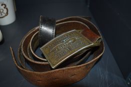 Two vintage leather and brass buckled belts