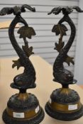A pair of mantle or side table figural lamp bases of classical mythical sea beasts cast in solid