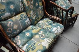 A modern three piece bamboo style conservatory suite