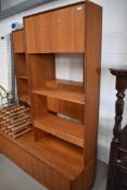 A selection of vintage teak , probably G plan, wall shelves with base units