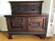 A Victorian mahogany ledge back sideboard, extensively carved with central lion mask , interior