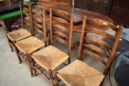 A set of four traditional oak rush seated ladder back chairs