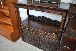 A 19th Century and later oak buffet, heavily carved frieze, drawers and panelled cupboards, drawer